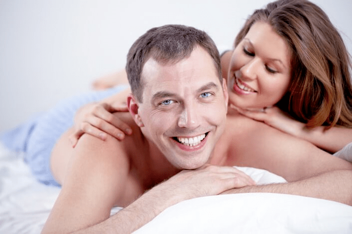Male and woman in bed